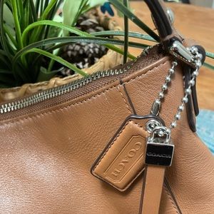 Coach leather handbag neutral color.